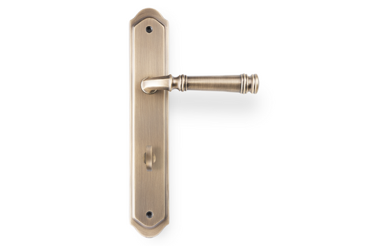 Product picture of the Apollo Design Tuscany Door Handle on Traditional Plate Antique Brass Privacy Set on a white background.