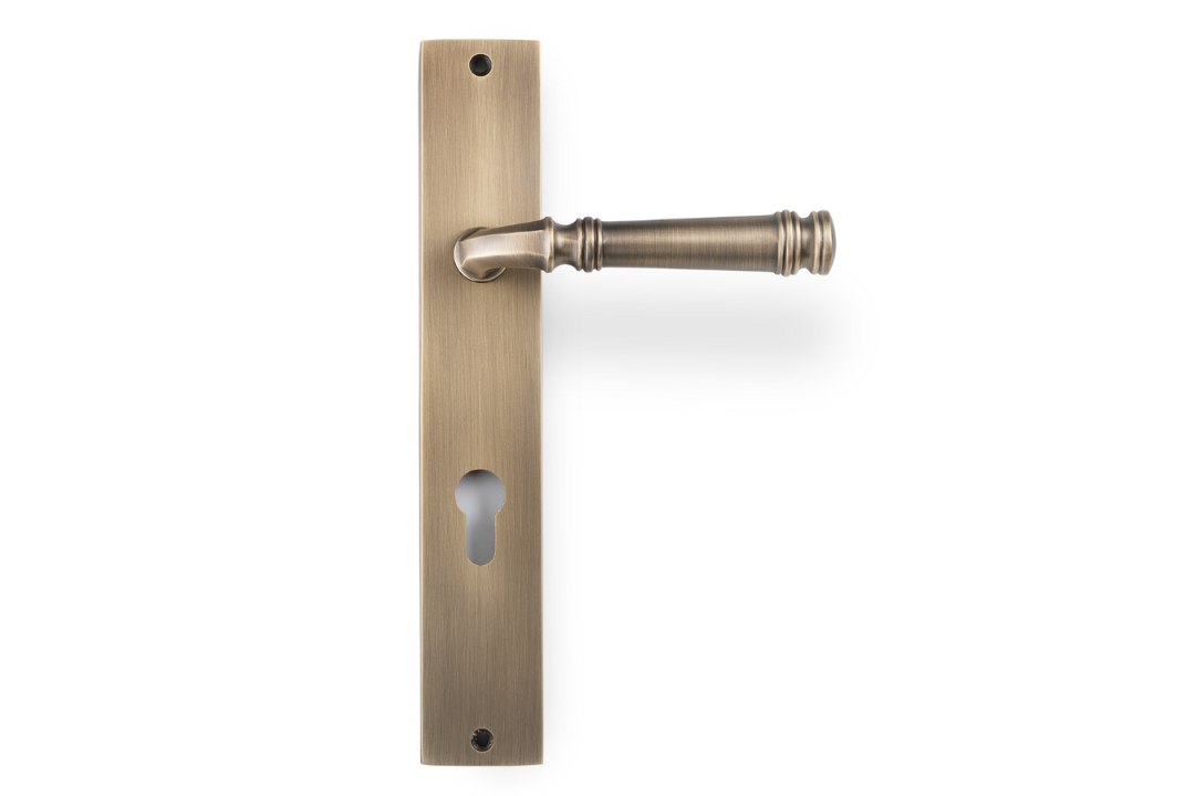 Product picture of the Apollo Design Tuscany Door Handle on Rectangle Plate Antique Brass Euro Set on a white background.