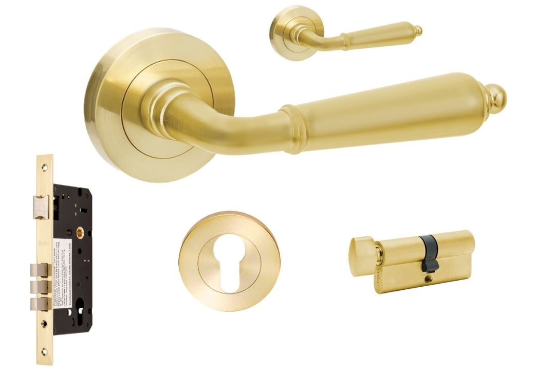 Gold door handle set with lock and key on a white background