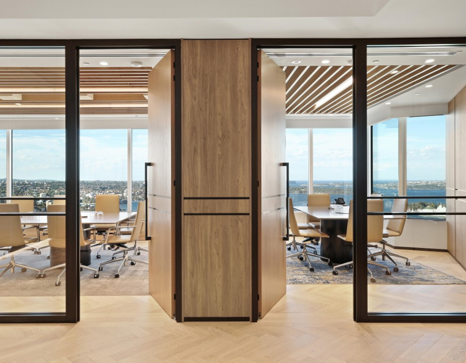 Two adjoining offices with light wooden doors that have the Polo Matt Black pull handle installed.