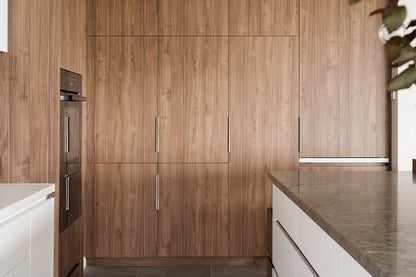 Insitu image of the Brushed Nickel Lip Pull installed on wooden cabinetry.