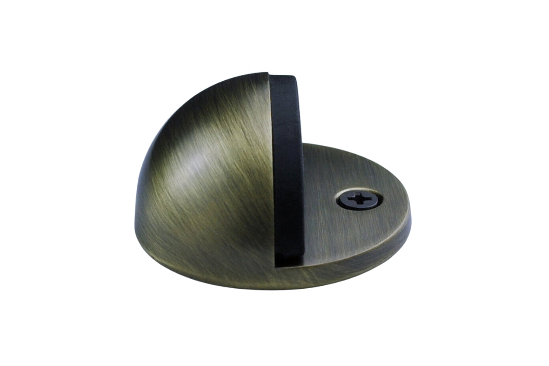 Product picture of the Antique Brass Oval Door Stop on a white background.
