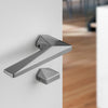 Modern door handle on a white door with a blurred background
