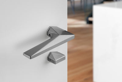 Modern door handle on a white door with a blurred background