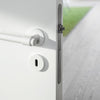 Insitu image of the IN.00.145.W Brooklyn White Door Handle set installed on a white door with an outdoor footpath in the background.