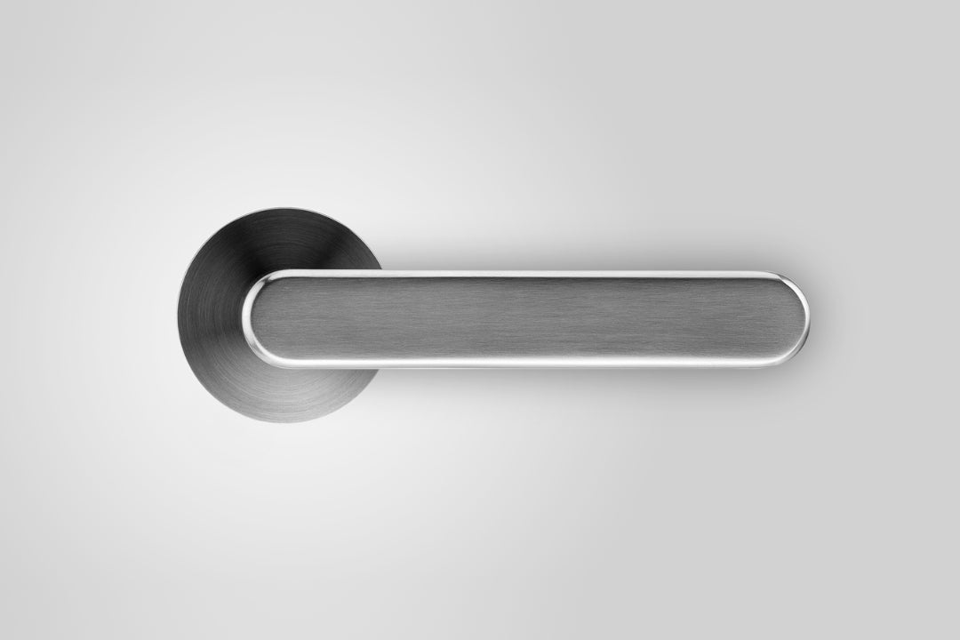 Insitu front on photo of the Yokohama Brushed Chrome Door Handles on an off white background.