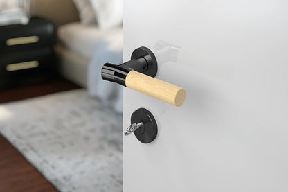 JNF Wood Nature IN.00.381.BB.TB Bamboo Titanium Black lever handle on a white door with a blurred background.