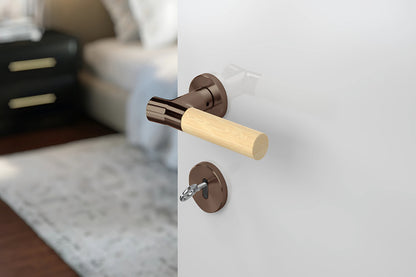 JNF Wood Nature IN.00.381.BB.TCO Bamboo Titanium Chocolate lever handle on a white door with a blurred background.