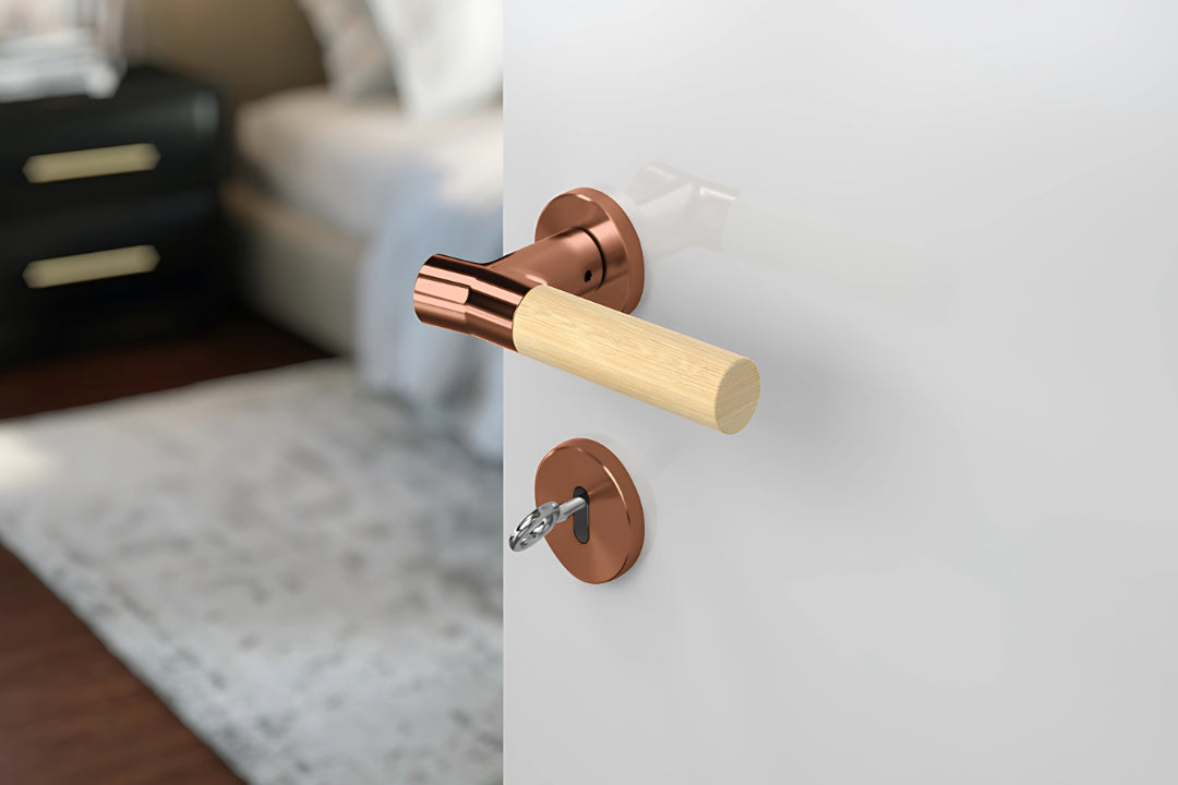 JNF Wood Nature IN.00.381.BB.TCO Bamboo Titanium Copper lever handle on a white door with a blurred background.