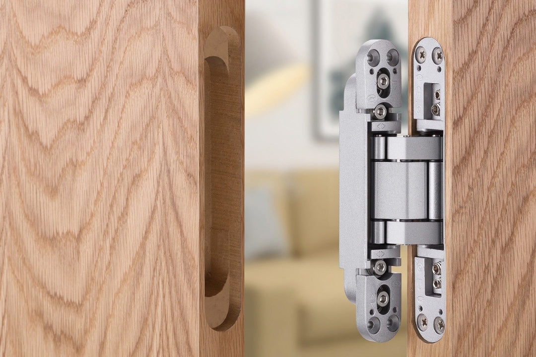 Insitu image of the IN.05.062 3D Adjustable Concealed Hinge 175 Brushed Chrome installed on a wooden door without the covers.