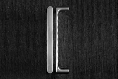 The JNF Yokohama Satin Stainless Steel Pull Handle Pair IN.07.177 laying down to show the ergonomic nature of the product.