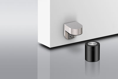 Insitu photo of the Heavy Duty Magnetic Door Stop installed on an off white door and a grey floor.