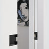 Insitu photo of the Matt Black Pocket Door Flush Pull 100mm on off white doors with a painting of a face in the background.