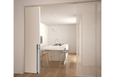 Image of the IN.16.302.M4 Satin Stainless Flush Handle installed on a cream door that is open and looking into a kitchen.