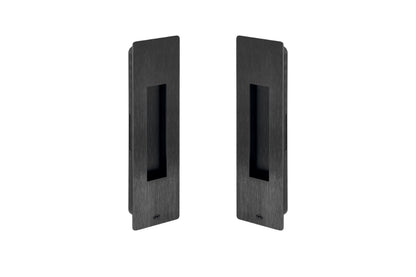 Two black rectangular door handles on a white background