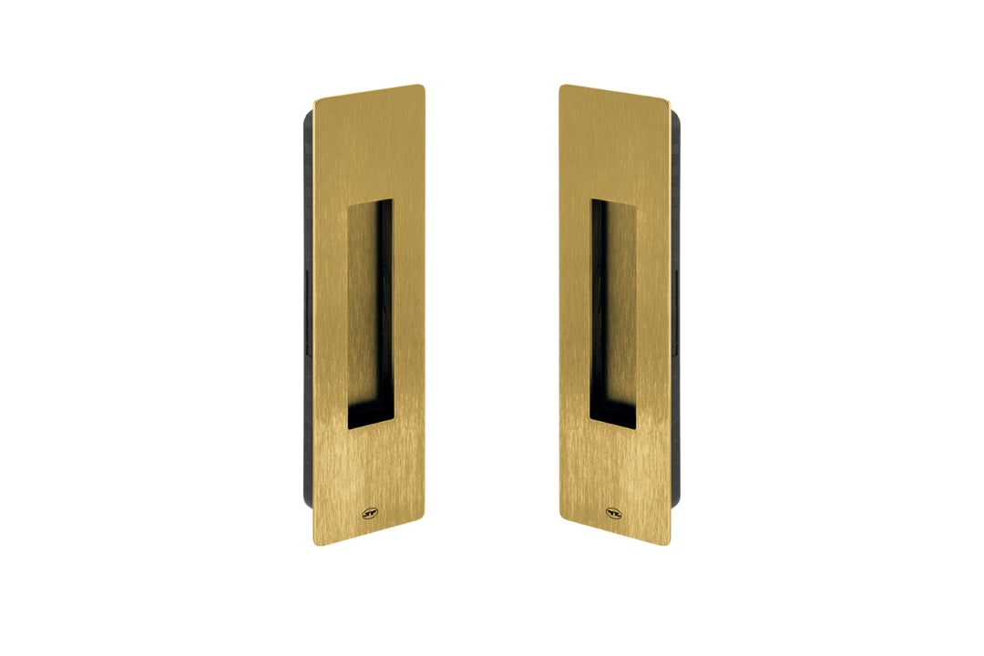 Two gold rectangular door handles on a white background