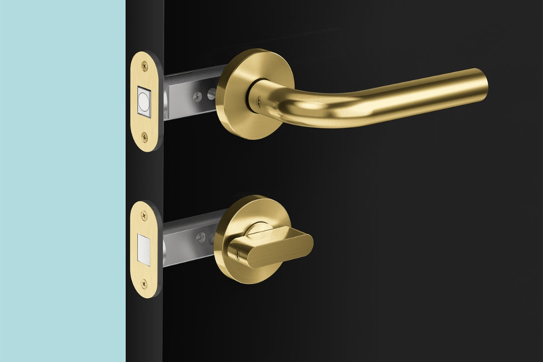 Insitu image of the Satin Brass Privacy Bolt on a black door with a lever set installed.