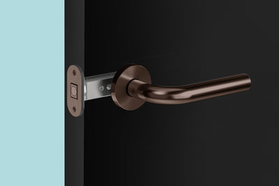 Insitu image of the IN.20.153.TCH Tube latch on a black door with a generic antique brass lever installed.
