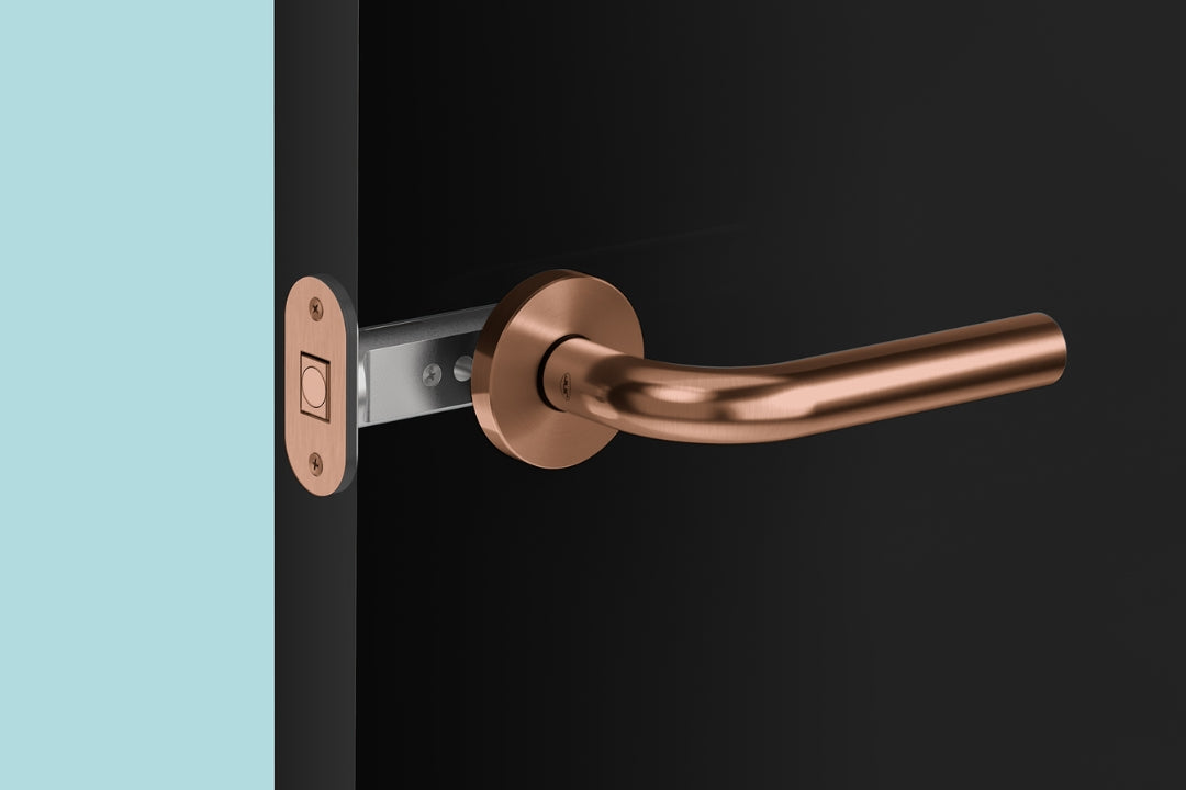 Insitu image of the IN.20.153.TCO magnetic latch on a black door with a generic copper door handle.