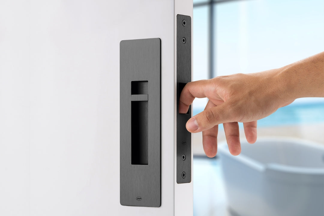 Hand opening a door with a modern black handle