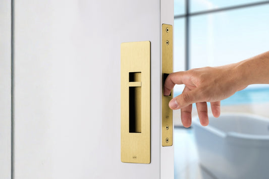 Hand opening a door with gold handle