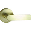 Image of the Satin Brass Nidus Spring Door Lever Round Passage Set on a white background.