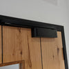 Insitu image of the Matt Black Door Closer with Slide Arm installed on a wooden door.