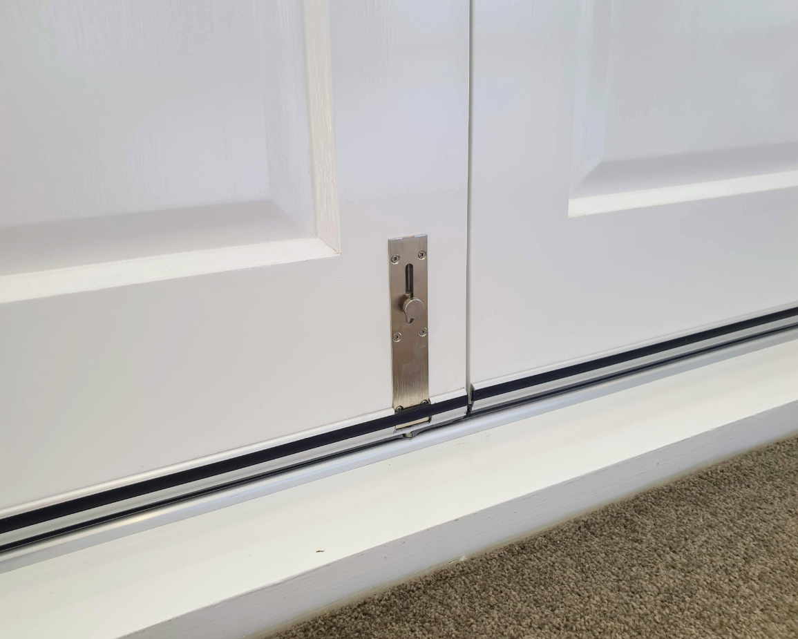 Picture of the Reverse Barrel Bolt installed on a set of white French doors.