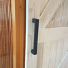 The 300mm Polo Matt Black Pull Handle installed on a wooden barn door.