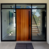 An 1800mm Polo Matt Black pull handle installed on a vanished wooden door with glass on either side of the door.