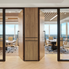 Two adjoining offices with light wooden doors that have the Polo Matt Black pull handle installed.