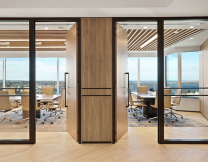 Two adjoining offices with light wooden doors that have the Ultra Matt Black pull handle installed.